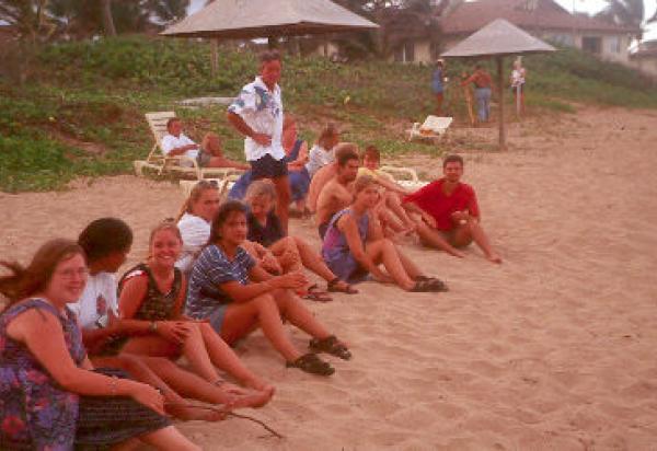 Students sitting on beach