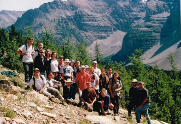 Group shot of students on steep slope with mountains in background