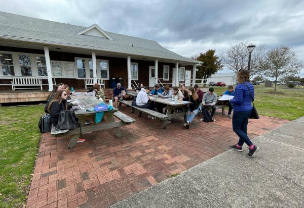 Students siting at a picnic table