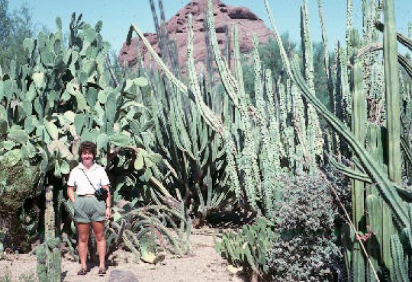 Student posing in cactus gardent