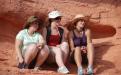 Three female students sitting in desert